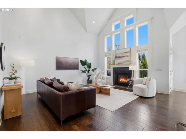 a living room with furniture wooden floor and a fireplace