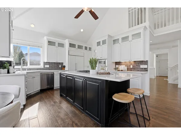 a kitchen with a sink cabinets and wooden floor