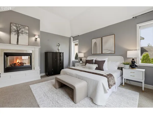 a spacious bedroom with a bed and a fireplace