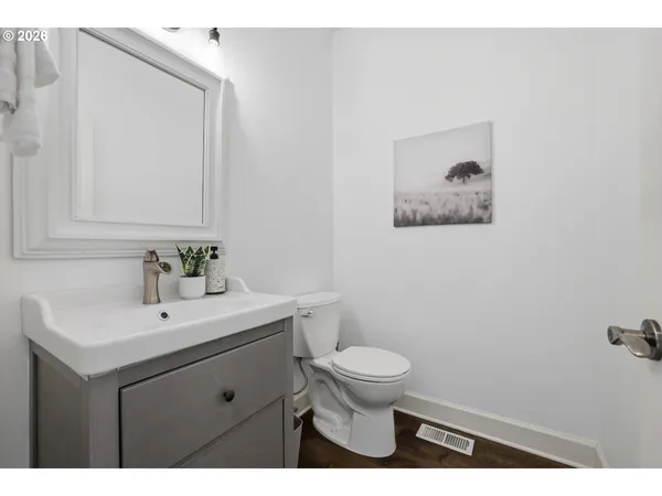 a bathroom with a sink mirror and toilet