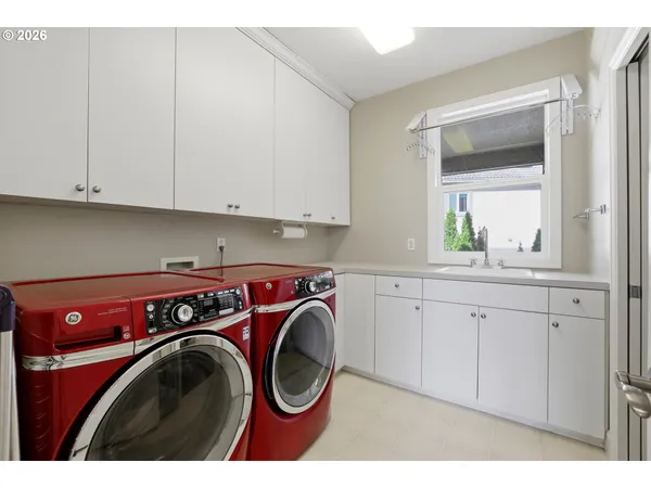 a utility room with sink dryer and washer