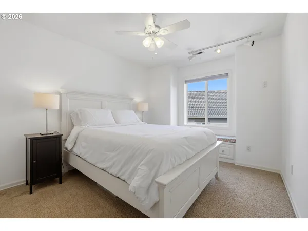 a bedroom with a bed and a night stand