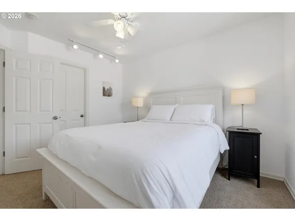 a bedroom with a bed and a lamp