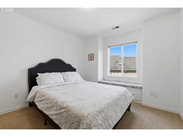 a bedroom with a bed and a window