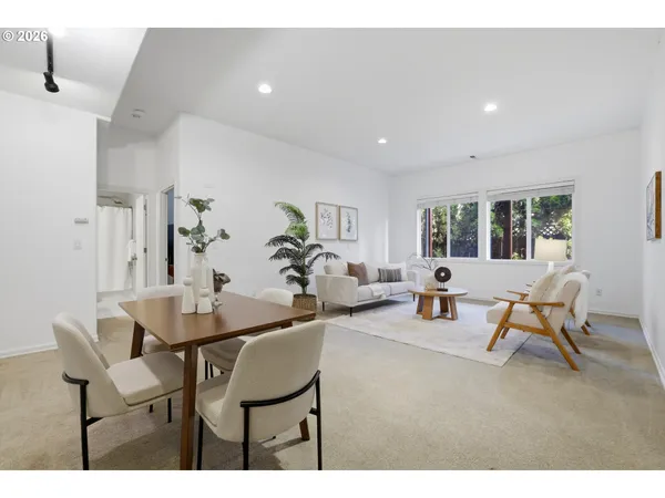 a living room with furniture and a potted plant