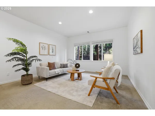 a living room with furniture and a potted plant