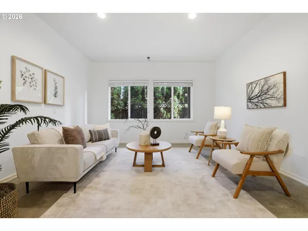 a living room with furniture and floor to ceiling window