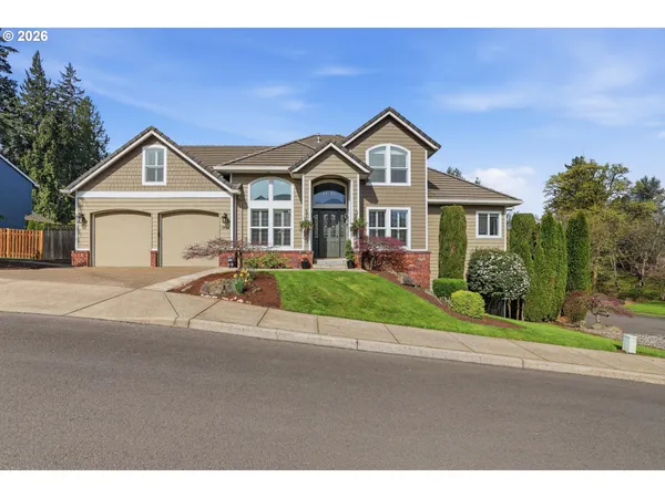 a front view of a house with a yard and garage