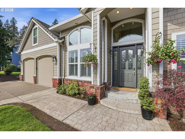 a front view of a house with a garden