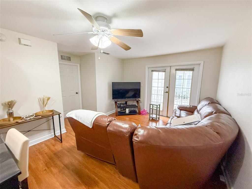 835 Southwest 9th Street, Unit 108 Gainesville, FL 32601 - Photo 3 of 9 a living room with furniture and a flat screen tv