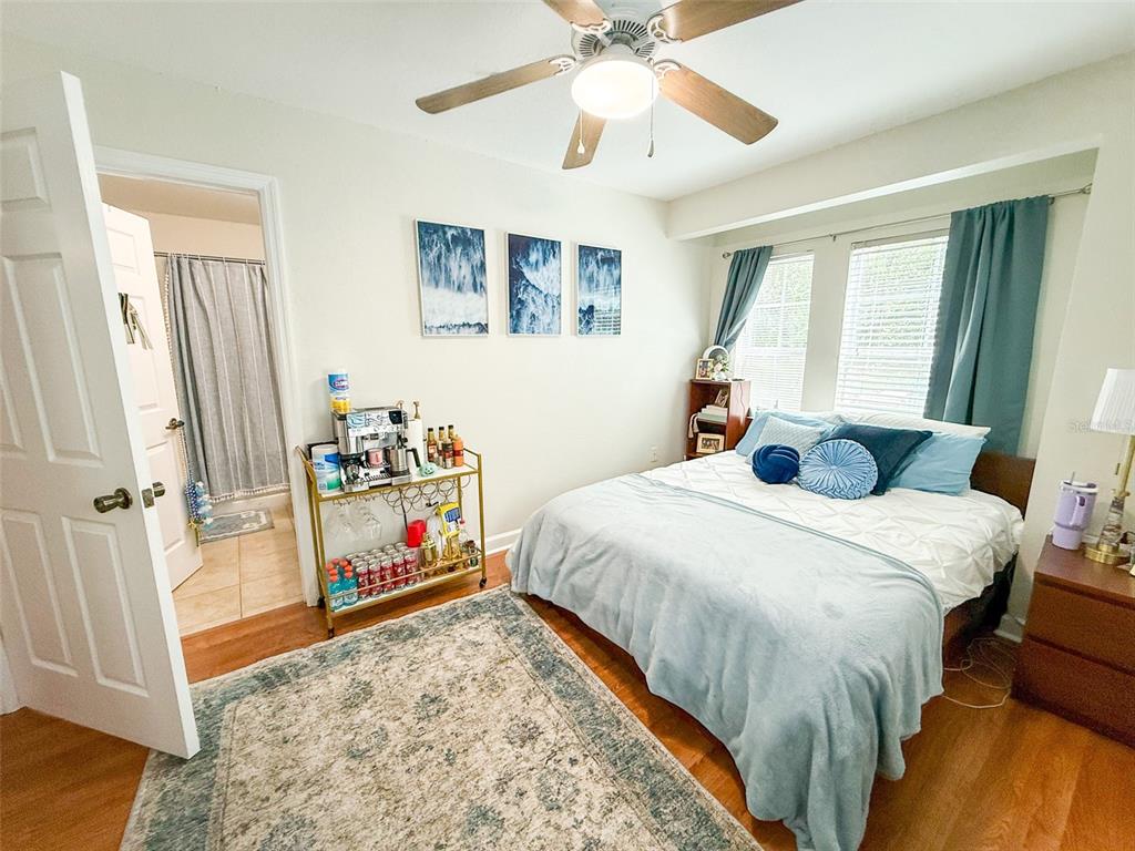 835 Southwest 9th Street, Unit 108 Gainesville, FL 32601 - Photo 9 of 9 a bedroom with a bed and a chandelier