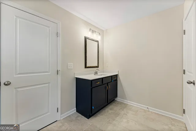 a room that has a sink and a mirror