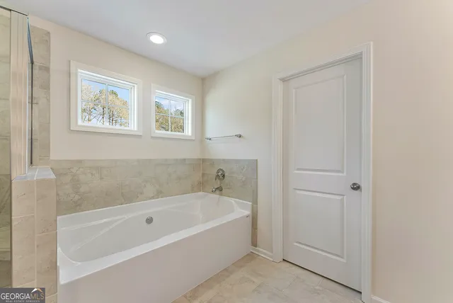 a white bath tub sitting next to a window