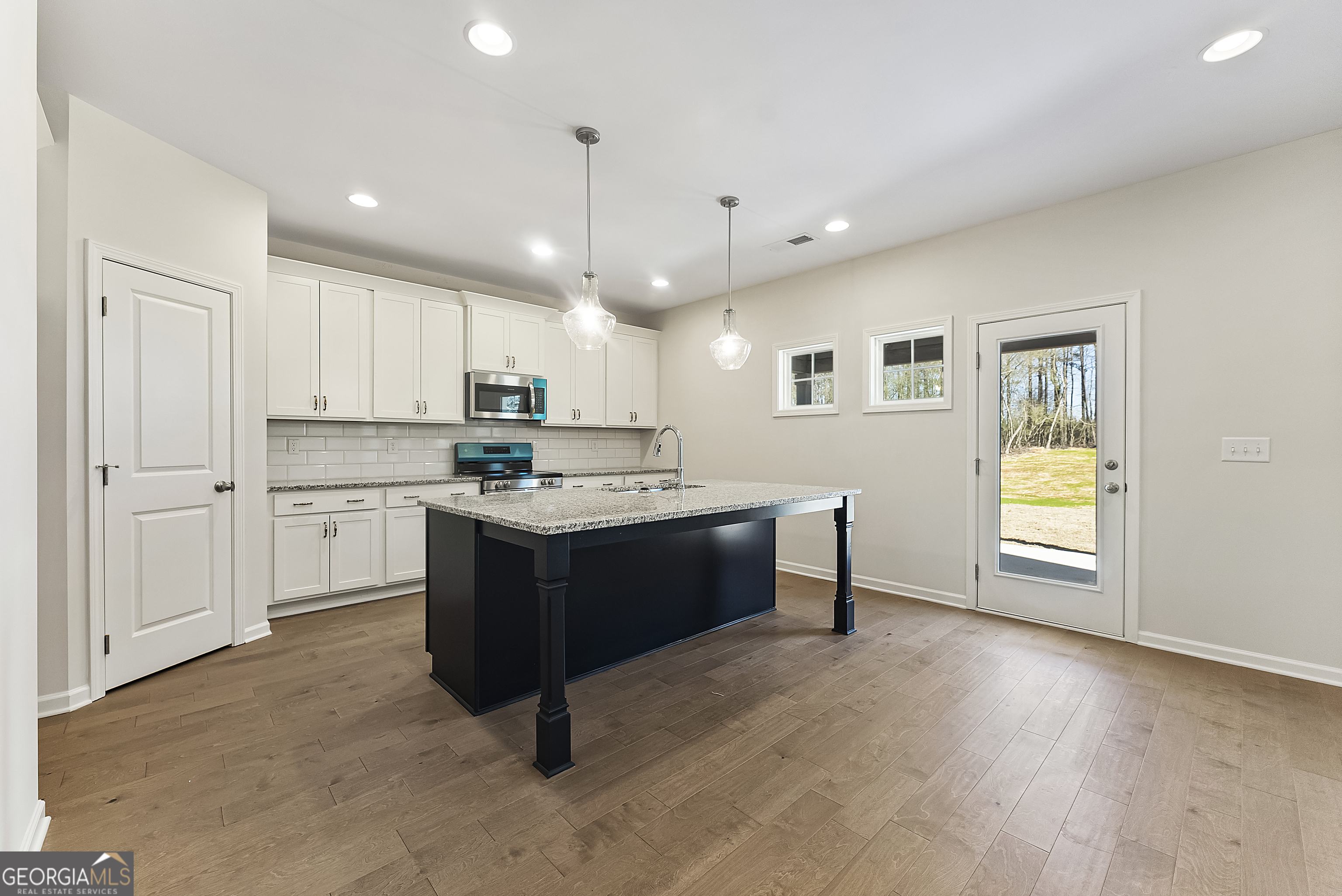 515 Bohannon Road, Unit 13 Grantville, GA 30220 - Photo 8 of 40 a kitchen with kitchen island granite countertop wooden cabinets and white appliances