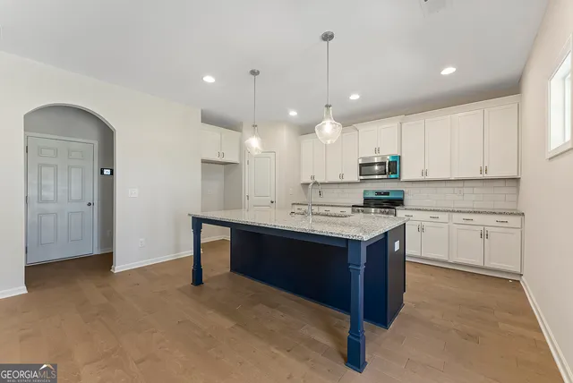 a kitchen with a sink cabinets and window
