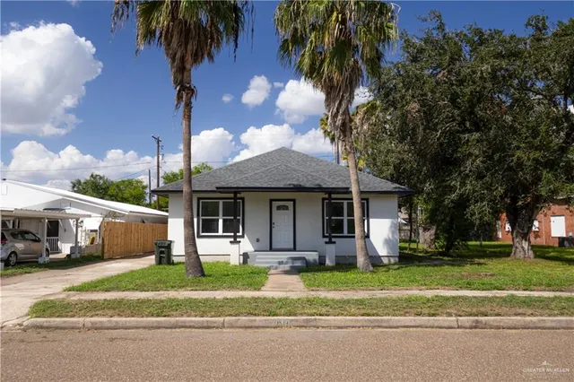 a front view of a house with garden and porch