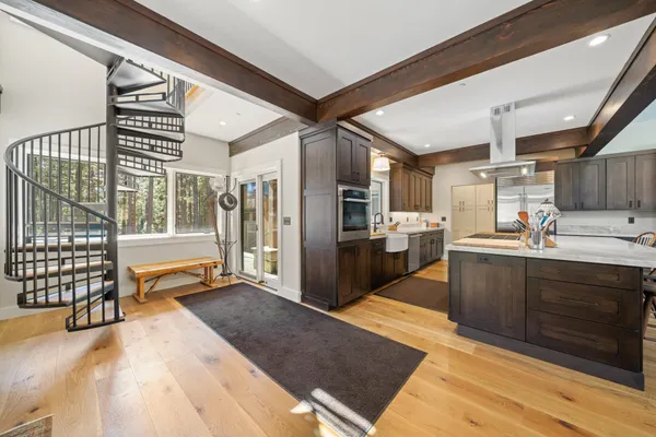 a kitchen with stainless steel appliances kitchen island granite countertop a refrigerator and stove