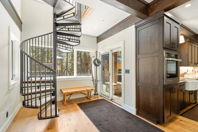 a dining room with furniture a rug and wooden floor