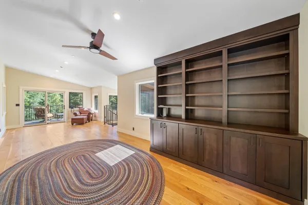 a spacious bedroom with a bed a couch and a large window