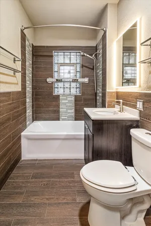 a bathroom with a sink a toilet and bathtub