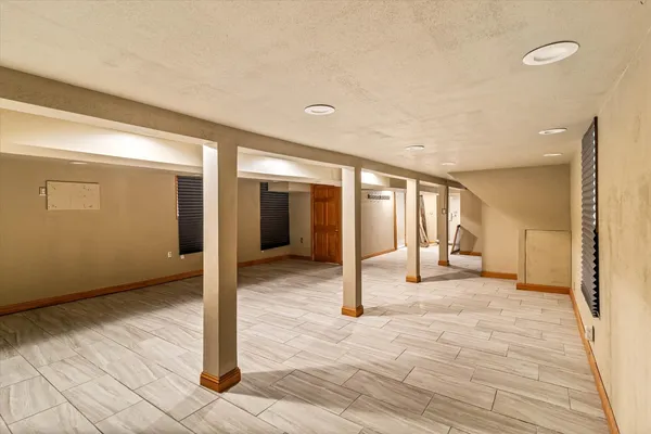 a view of a hallway with wooden floor and livingroom