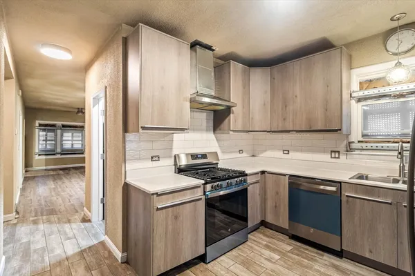 a kitchen with a sink stove and cabinets