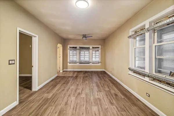 wooden floor in an empty room with a window
