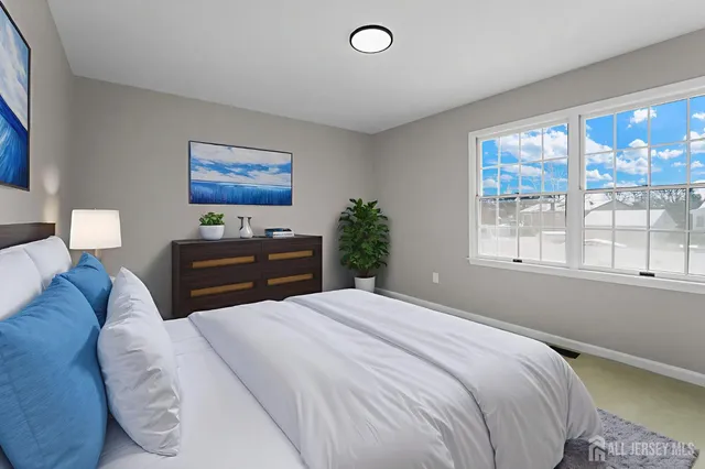 a bedroom with a bed and a large window