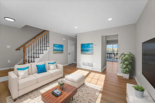 a living room with furniture and a potted plant