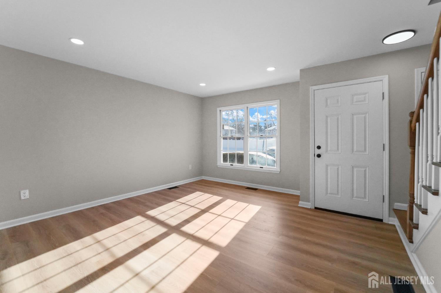 85 Wilton Avenue Middlesex, NJ 08846 - Photo 3 of 25 an empty room with wooden floor and windows