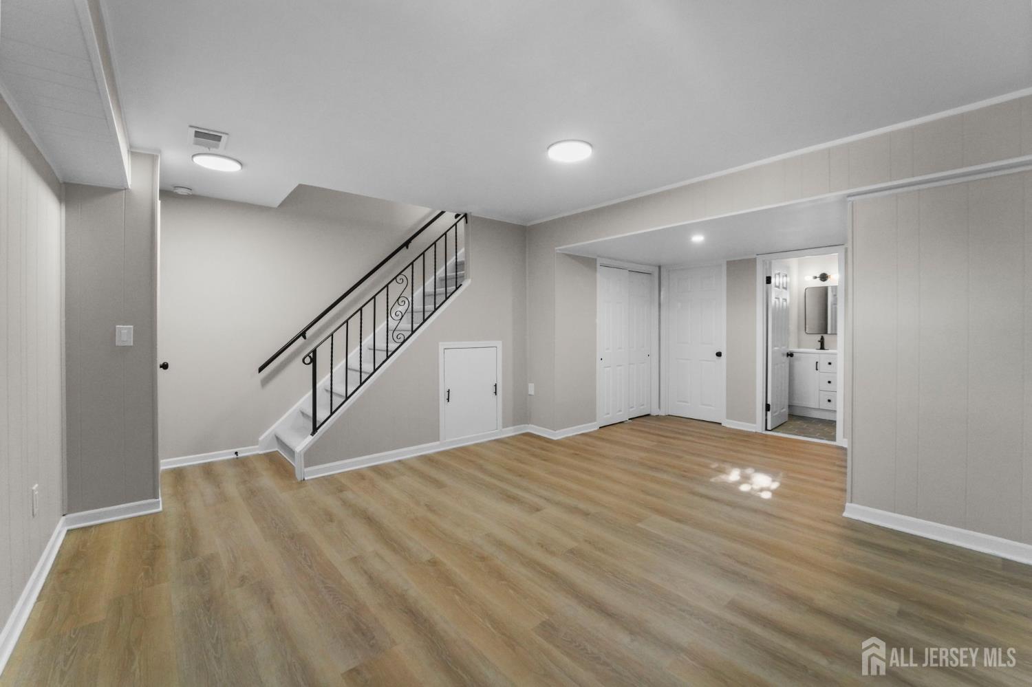 85 Wilton Avenue Middlesex, NJ 08846 - Photo 5 of 25 a view of an empty room with wooden floor and stairs