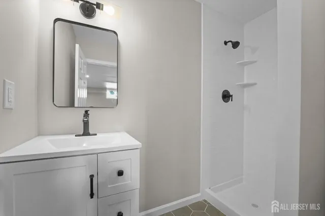 a bathroom with a sink a vanity and a mirror