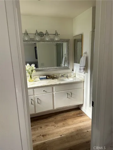 a bathroom with a sink a vanity and mirror