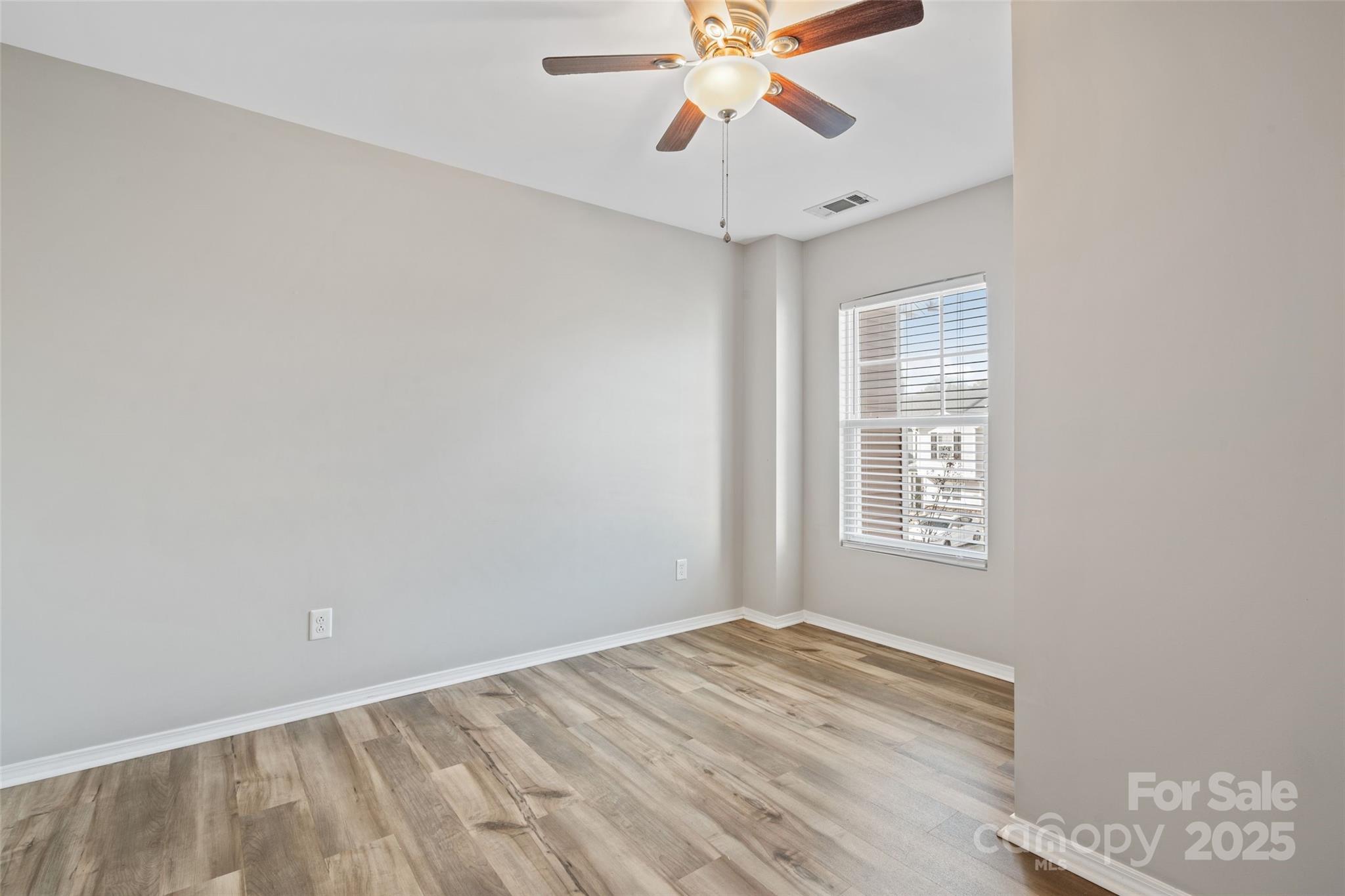 325 River Clay Road Fort Mill, SC 29708 - Photo 6 of 15 an empty room with a window and a fan