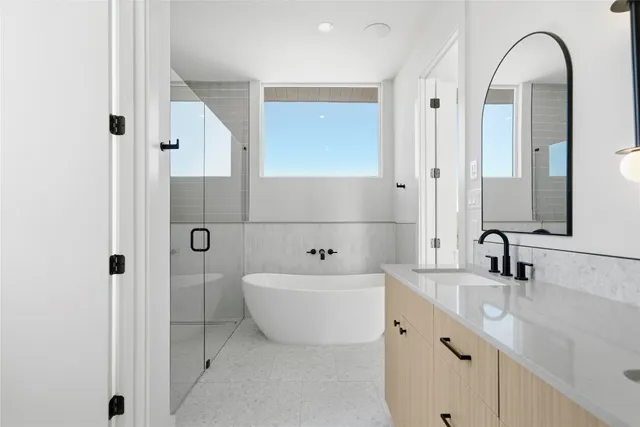 a bathroom with a double vanity sink mirror and shower