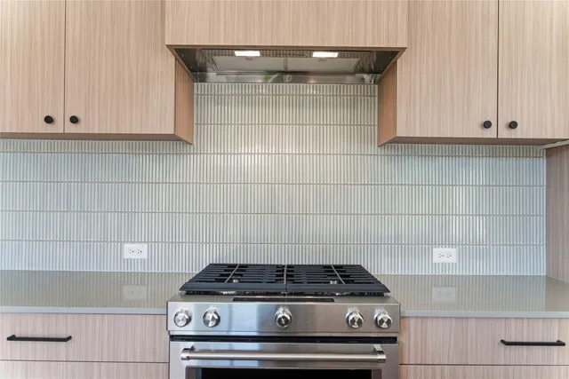 a stove top oven sitting inside of a kitchen
