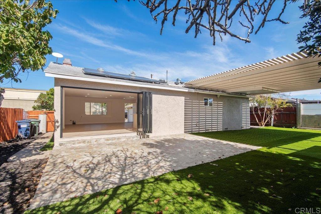 8739 St George Street Spring Valley, CA 91977 - Photo 11 of 30 a front view of a house with a yard and garage