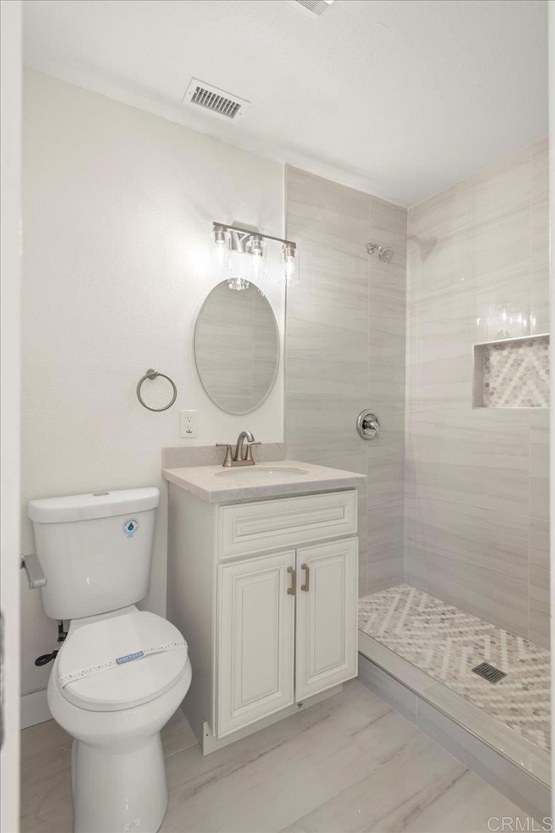 8739 St George Street Spring Valley, CA 91977 - Photo 18 of 30 a bathroom with a toilet sink and shower