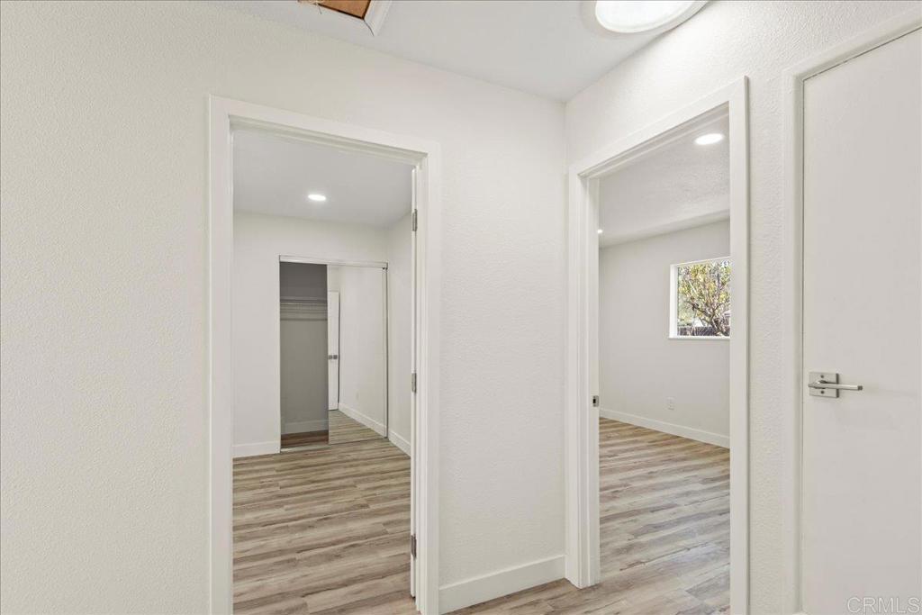 8739 St George Street Spring Valley, CA 91977 - Photo 19 of 30 a view of a hallway with wooden floor and closet