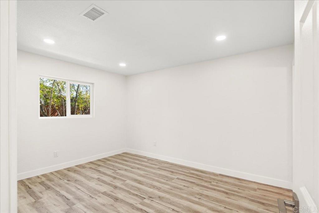 8739 St George Street Spring Valley, CA 91977 - Photo 23 of 30 a view of empty room with wooden floor and fan