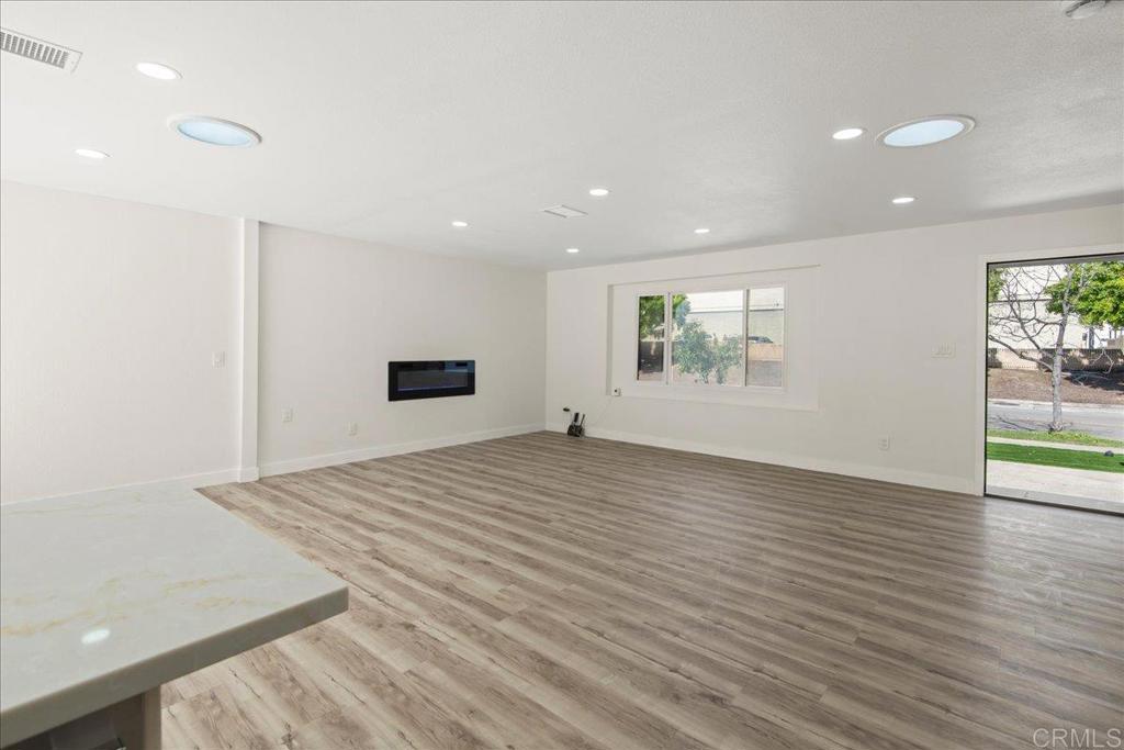 8739 St George Street Spring Valley, CA 91977 - Photo 6 of 30 a view of empty room with wooden floor and fan