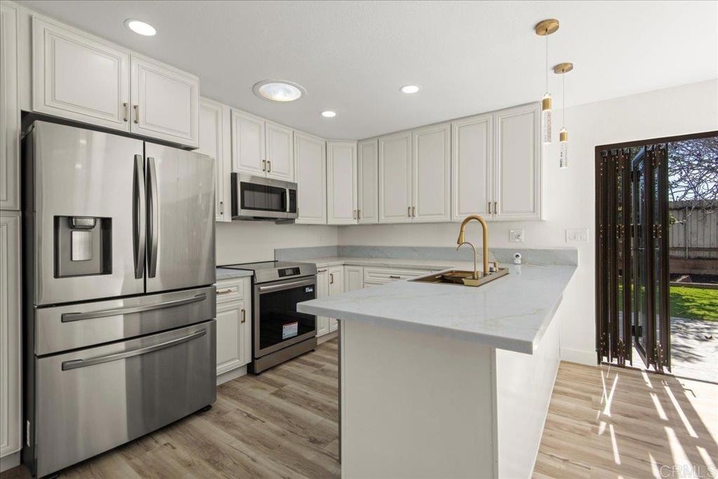 8739 St George Street Spring Valley, CA 91977 - Photo 8 of 30 a kitchen with stainless steel appliances a refrigerator stove and sink