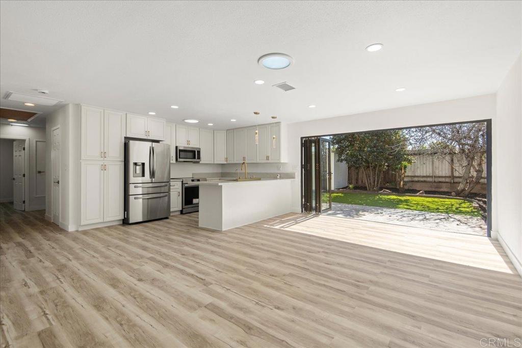 8739 St George Street Spring Valley, CA 91977 - Photo 9 of 30 a view of a kitchen with a sink and an oven