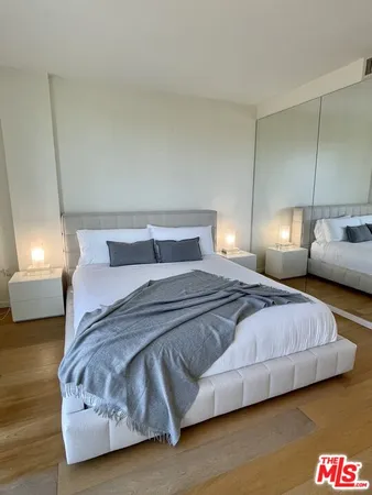 a bedroom with a bed and a lamp