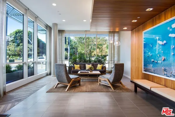 a living room with furniture and large windows