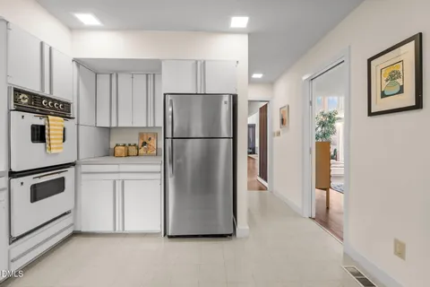 a kitchen with stainless steel appliances a refrigerator a stove a microwave and cabinets