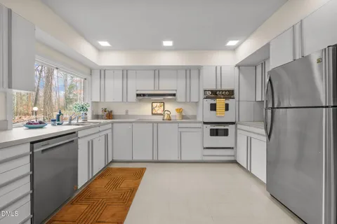 a kitchen sink with a granite countertop window and sink