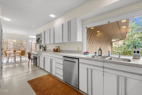 a kitchen with stainless steel appliances granite countertop a sink and a stove