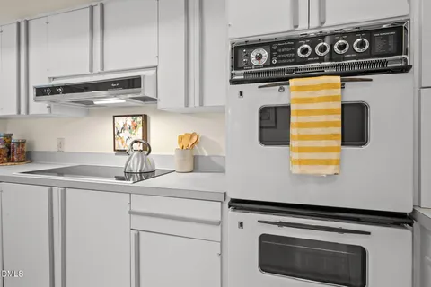 a kitchen with dining table and chairs