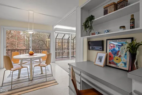 a living room with furniture a rug and a lamp